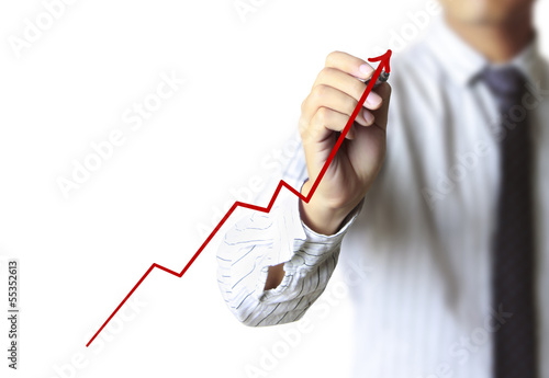 Photo: Business man drawing a graph Business man drawing a graph