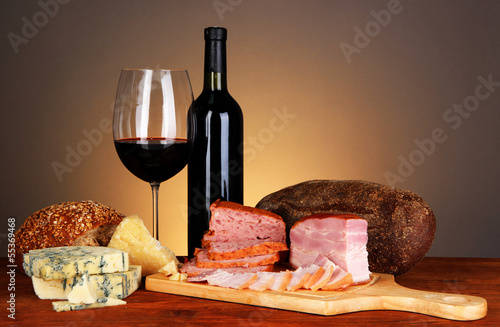 Photo: Exquisite still life of wine, cheese and meat products Exquisite still life of wine, cheese and meat products