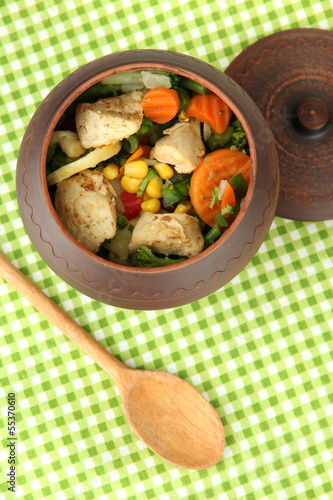 Photo: Baked mixed vegetable with chicken breast in pot, isolated Baked mixed vegetable with chicken breast in pot, isolated