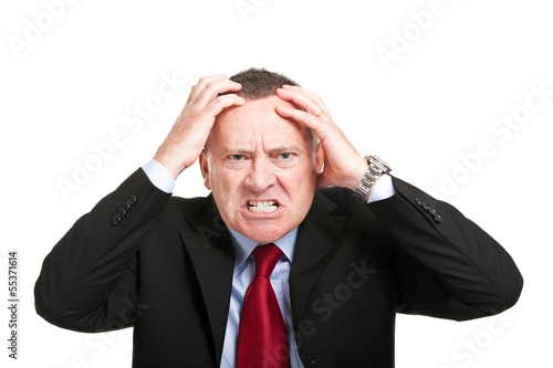 Photo: Angry businessman with hands in his head isolated on white Angry businessman with hands in his head isolated on white