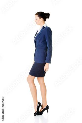Photo: Side view of walking elegant businesswoman Side view of walking elegant businesswoman