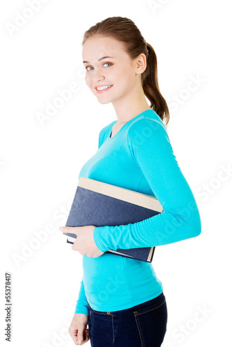 Photo: Young caucasian woman (student) with book Young caucasian woman (student) with book