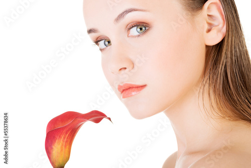 Photo: Beauty face of the young beautiful woman with flower. Beauty face of the young beautiful woman with flower.