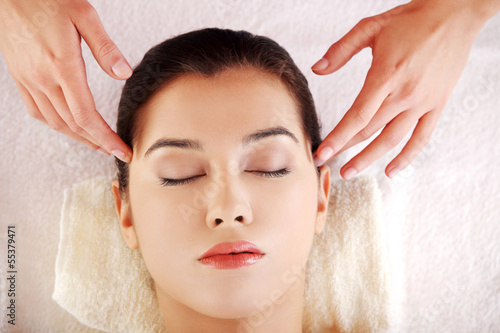 Photo: Young relaxed woman enjoy receiving massage Young relaxed woman enjoy receiving massage