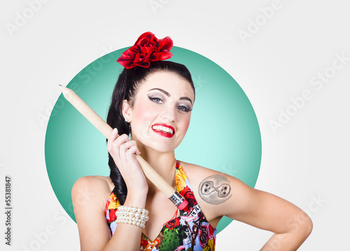 Photo: Beautiful pin-up girl getting skull tattoo stencil Beautiful pin-up girl getting skull tattoo stencil