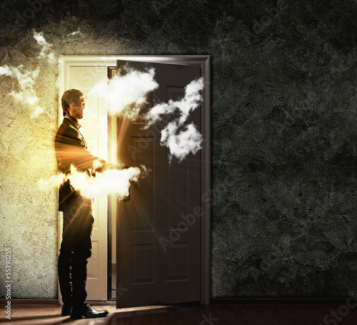 Photo: Young businessman opening door Young businessman opening door
