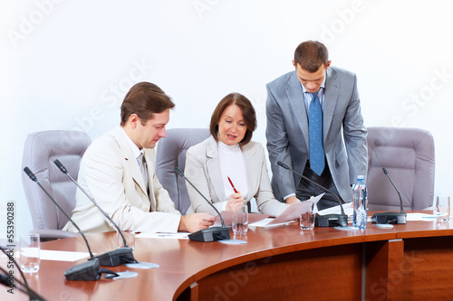 Photo: Three businesspeople at meeting Three businesspeople at meeting