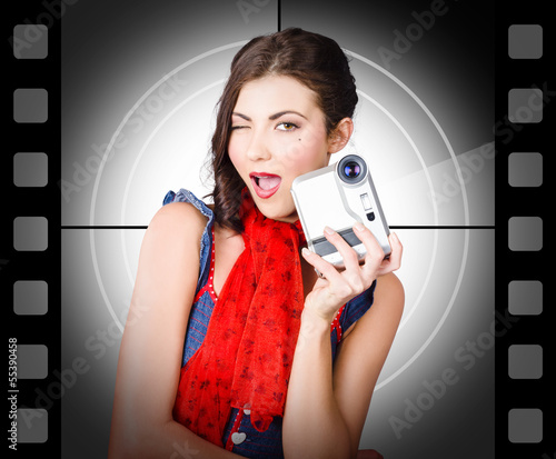 Photo: Beautiful woman holding home video camera Beautiful woman holding home video camera