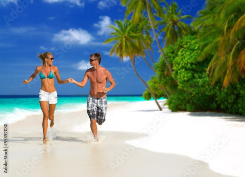 Photo: Running couple on the beach Running couple on the beach