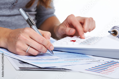 Photo: Hands of business people with calculator. Hands of business people with calculator.