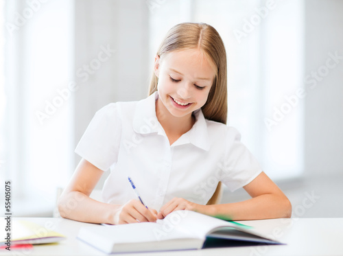 Photo: student girl studying at school student girl studying at school