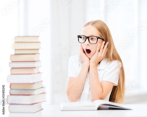 Photo: girl with many books at school girl with many books at school