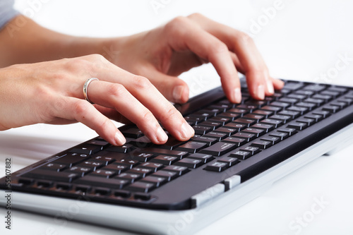 Photo: Hands with a computer keyboard. Hands with a computer keyboard.