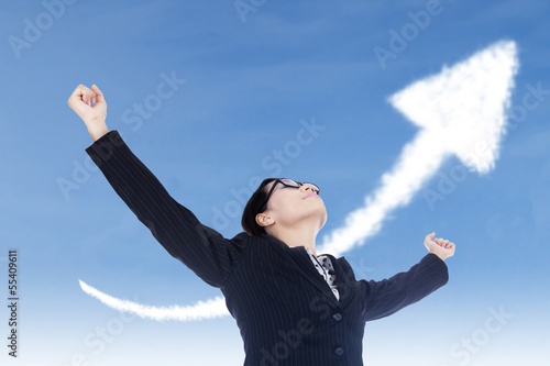 Photo: Businesswoman freedom gesture with up arrow sign Businesswoman freedom gesture with up arrow sign