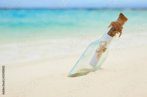 Photo: A letter in a bottle on the beach A letter in a bottle on the beach