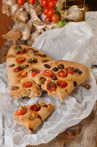 Photo: Focaccia with tomato, fresh garlic and black olives. Focaccia with tomato, fresh garlic and black olives.