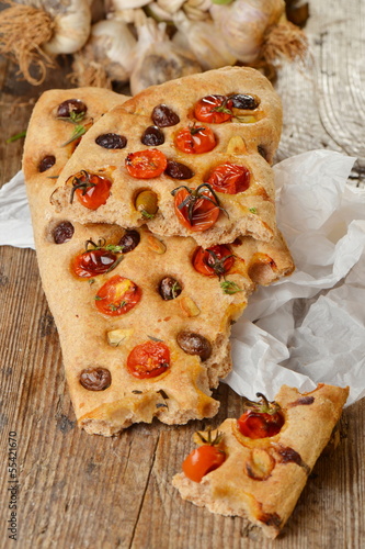 Photo: Focaccia with tomato, fresh garlic and black olives. Focaccia with tomato, fresh garlic and black olives.
