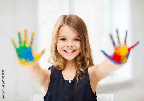 Photo: girl showing painted hands girl showing painted hands