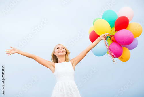 Photo: woman with colorful balloons outside woman with colorful balloons outside