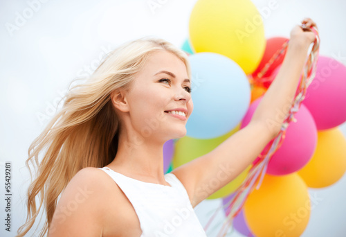 Photo: woman with colorful balloons outside woman with colorful balloons outside