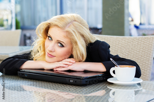 Photo: Young pretty business woman with notebook Young pretty business woman with notebook