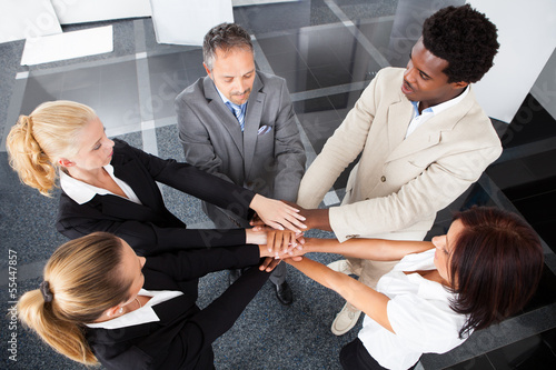 Photo: Multiracial Businesspeople Stacking Hands Multiracial Businesspeople Stacking Hands