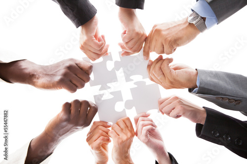 Photo: Businesspeople Holding Jigsaw Puzzle Businesspeople Holding Jigsaw Puzzle
