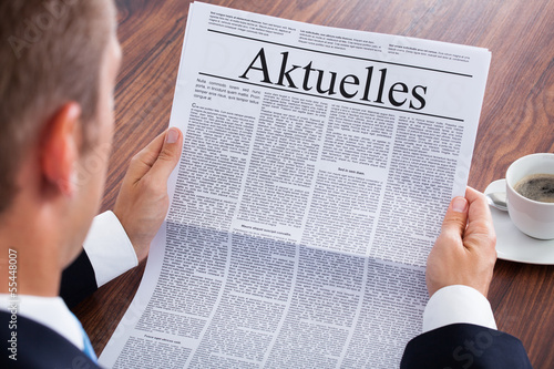 Photo: Businessman Reading Newspaper Businessman Reading Newspaper