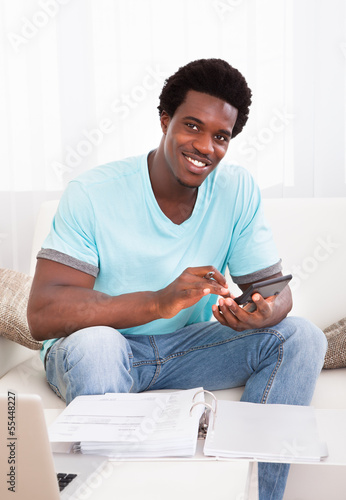 Photo: African Young Man Calculating African Young Man Calculating