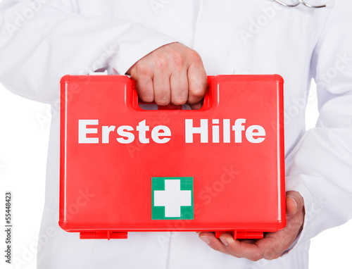 Photo: Male doctor carrying a portable first aid kit Male doctor carrying a portable first aid kit