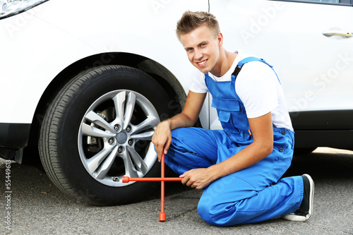 Photo: Auto mechanic changing wheel Auto mechanic changing wheel