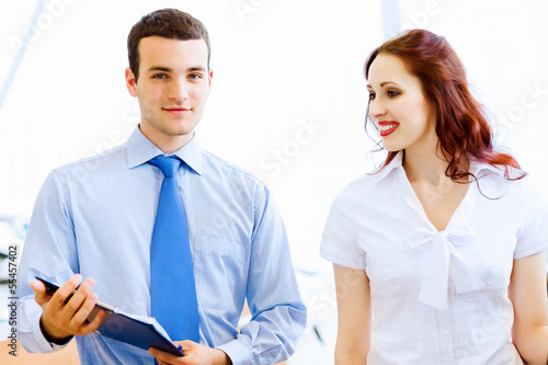 Photo: Young woman at car salon Young woman at car salon