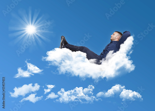 Photo: businessman relaxing on a cloud businessman relaxing on a cloud