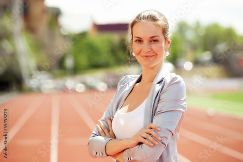 Photo: Business woman at athletic stadium Business woman at athletic stadium