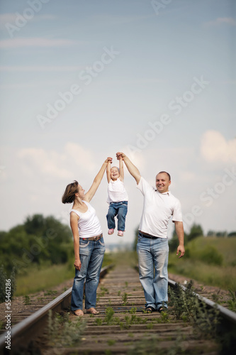 Photo: happy parents with baby on railroad happy parents with baby on railroad