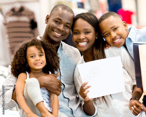 Photo: Family with a banner at a store Family with a banner at a store
