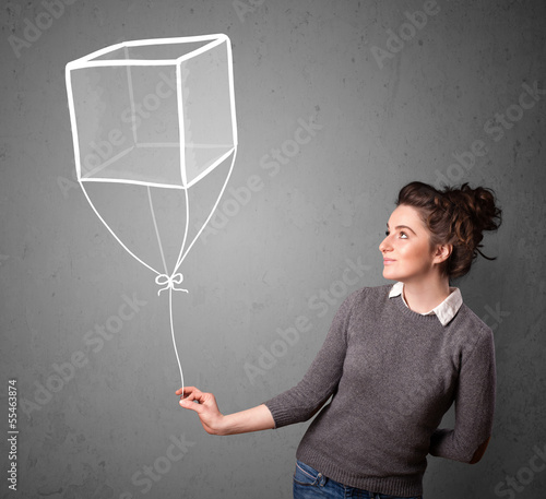 Photo: Woman holding a cube balloon Woman holding a cube balloon