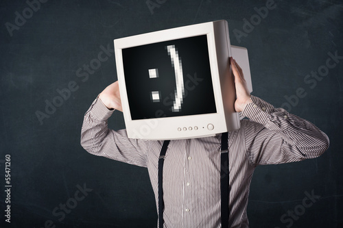 Photo: Funny young businessman with a monitor on his head and smiley on Funny young businessman with a monitor on his head and smiley on