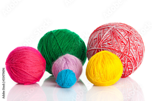 Photo: colorful different thread balls. wool knitting on white backgr colorful different thread balls. wool knitting on white backgr