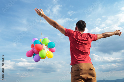 Photo: rear view of casual man with balloons rear view of casual man with balloons