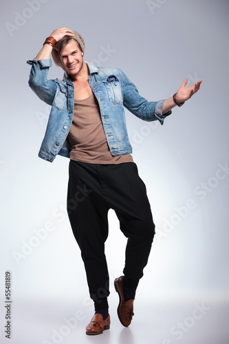 Photo: full length of casual man with hand on hat full length of casual man with hand on hat