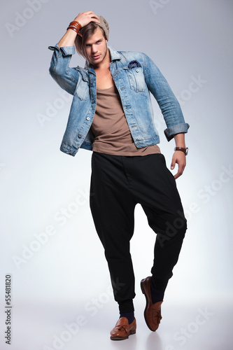 Photo: full length of casual man acting drunk full length of casual man acting drunk
