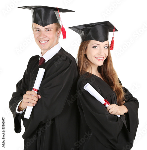 Photo: Two happy graduating students isolated on white Two happy graduating students isolated on white