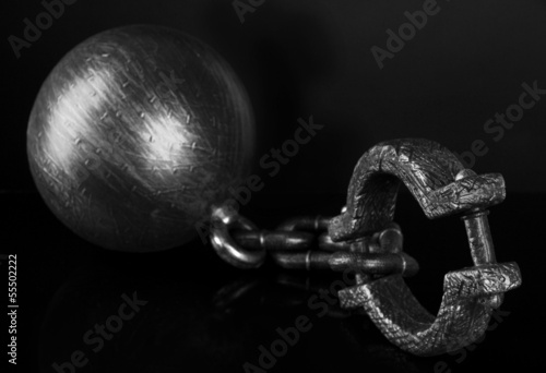 Photo: Ball and chain on black background Ball and chain on black background