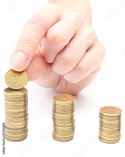 Photo: Hand put coins to stack of coins Hand put coins to stack of coins