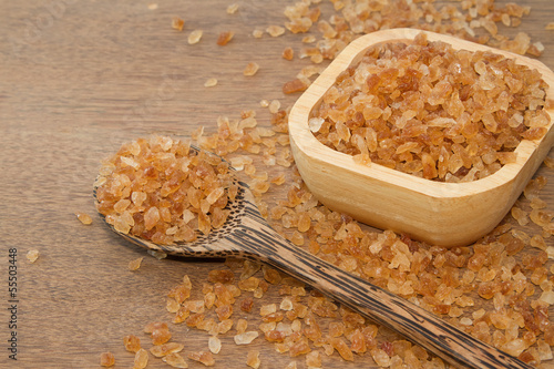 Photo: Organic rock candy sugar in wooden spoon Organic rock candy sugar in wooden spoon