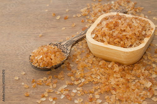 Photo: Organic rock candy sugar in wooden spoon Organic rock candy sugar in wooden spoon