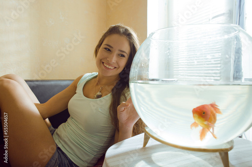 Photo: woman with goldfish at home, sunlight morning woman with goldfish at home, sunlight morning