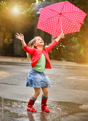Photo: Child with polka dots umbrella wearing red rain boots Child with polka dots umbrella wearing red rain boots