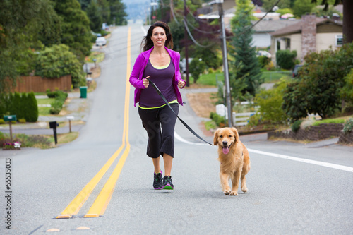 Photo: Woman jogging with dog Woman jogging with dog